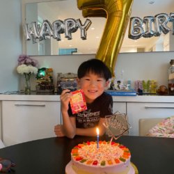 Little heroes birthday party: little boy with birthday cake
